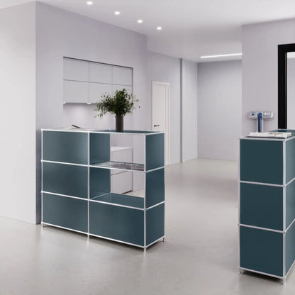 Small reception counter in petrol blue with 2 compartments for product presentation